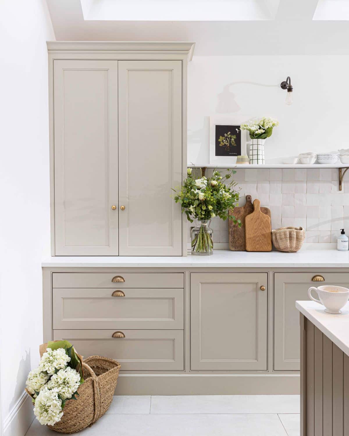 cream shaker kitchen with brass cup handles and knobs